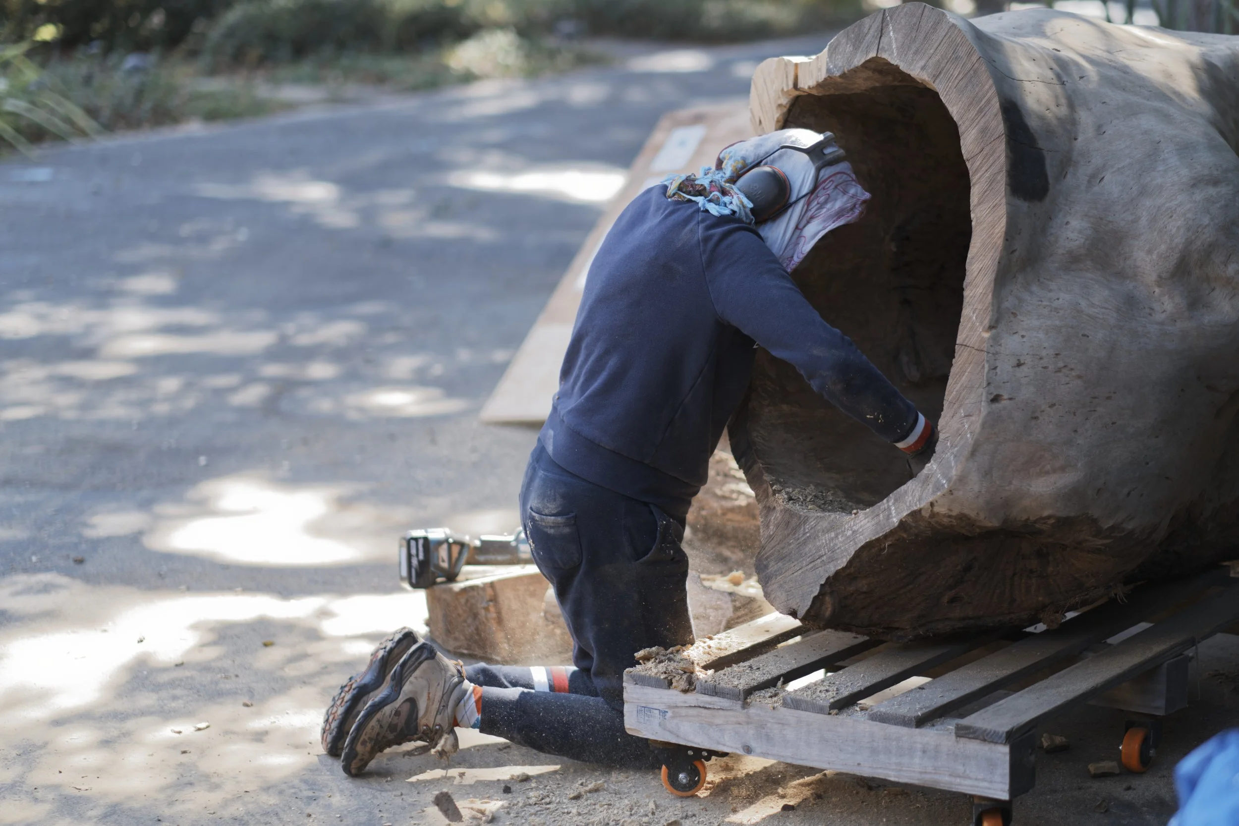 Studio record — shaping a large wood form.