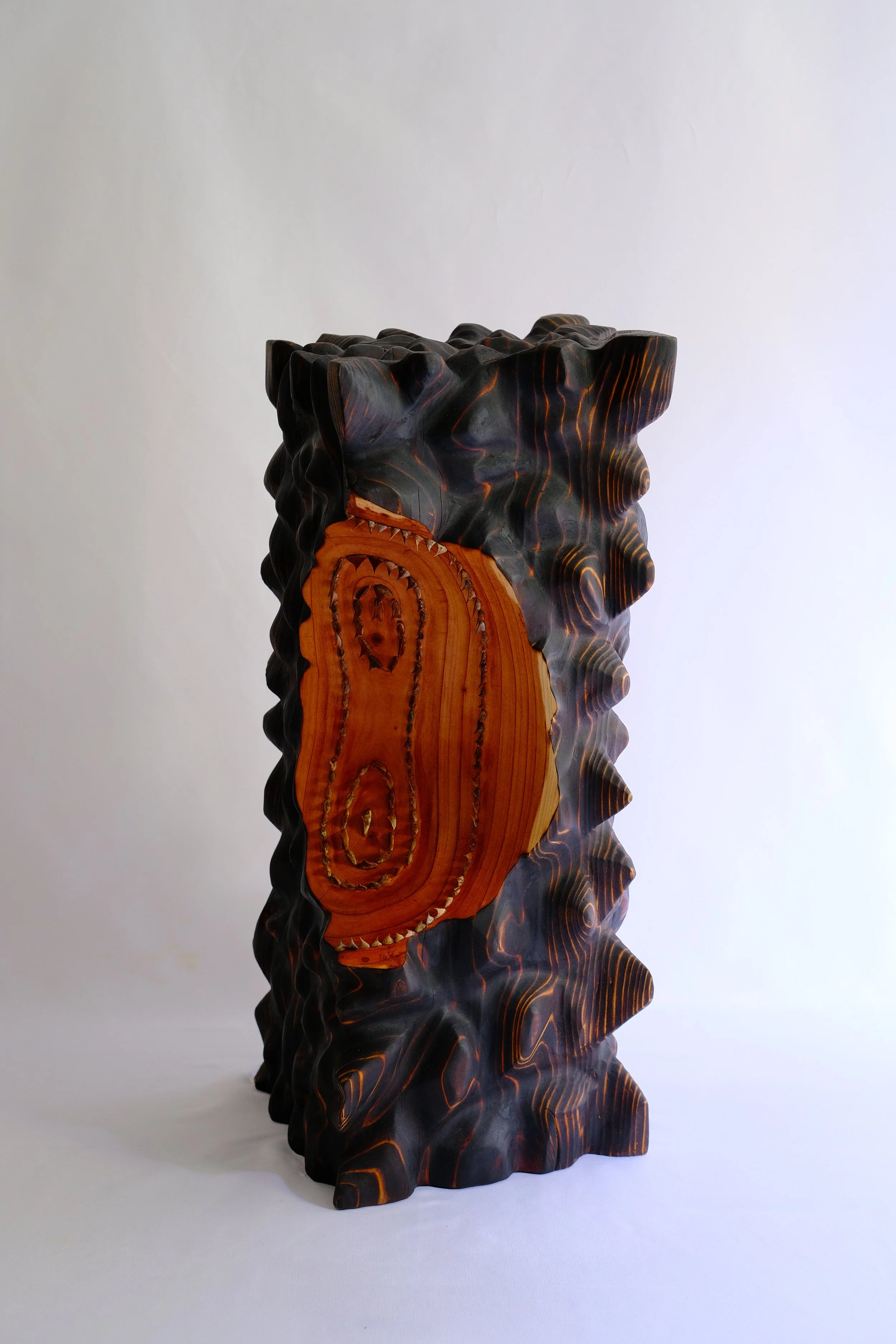 Taming the expectations — a charred oak sculpture set with rose prickles.