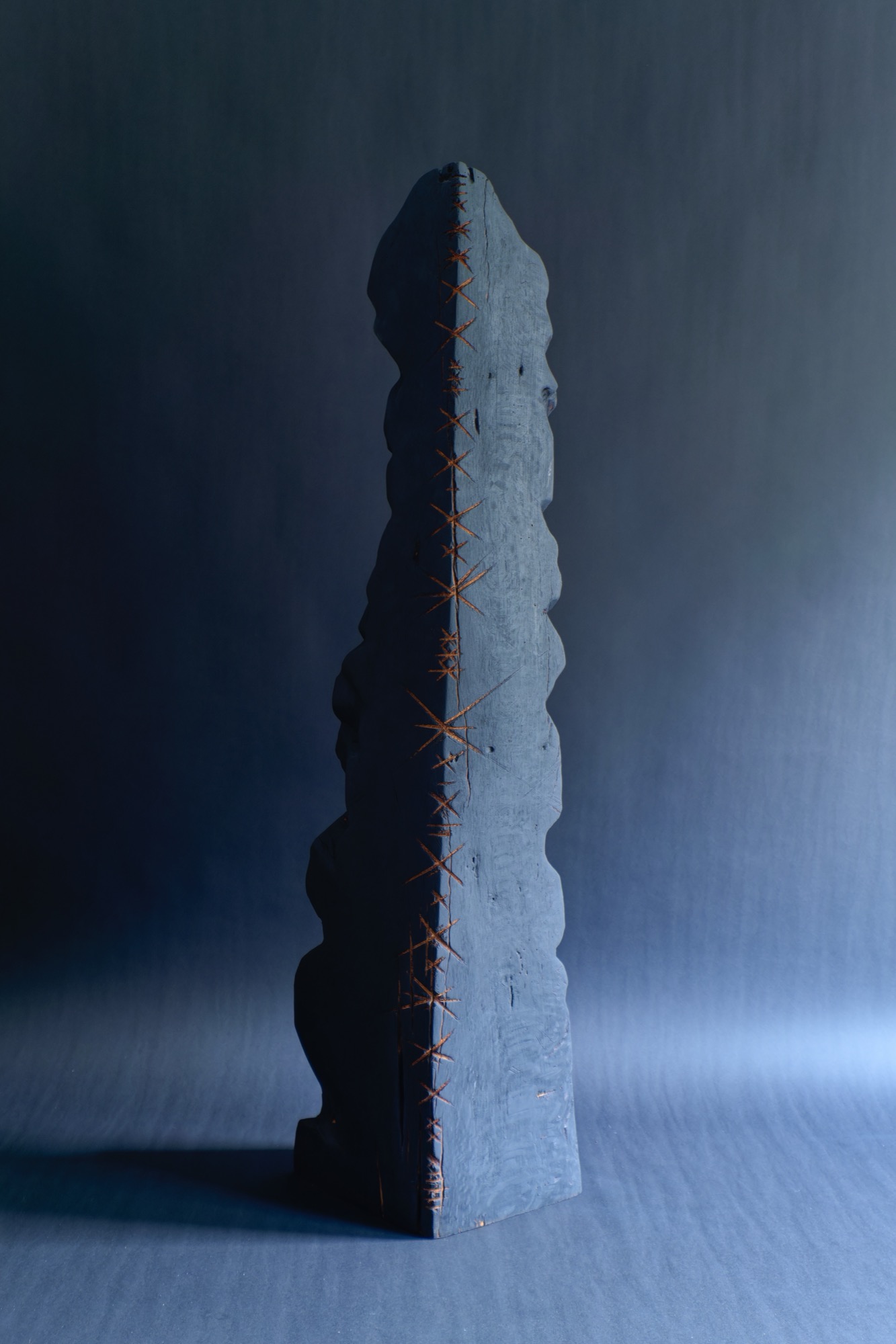 Healing III — a charred oak sculpture with a smooth carved hollow.